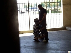 Parking lot blowie with two shadowy figures