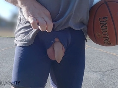 Exhibitionist guy shows off his basketball skills while stroking his hard cock on a public court