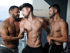 Fine male gets shared by two hunks in superb gay threesome
