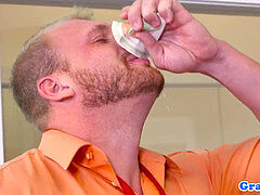 bulky guy plumbs bloke on office desk