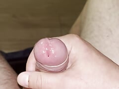 A young guy with a beautiful penis masturbates and cums close-up.