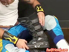 youthfull biker with tatts and piercings plays with his feet