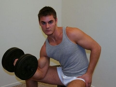 Brenden is jacking off furiously on a bed