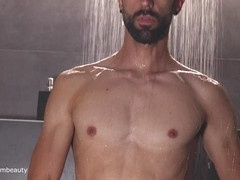 Well-endowed homosexual man enjoys a refreshing shower