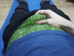 Young dude in green swim trunks enjoys stroking his dick