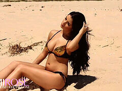 Sultry babe Demi Scott seductively poses to the rhythm of music on the beach