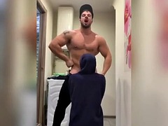 Bodybuilder strains muscles during blowjob