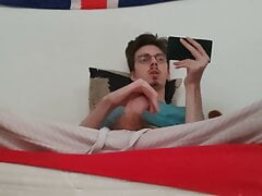 Twink jerks off his big cock and ejaculates while watching a porno