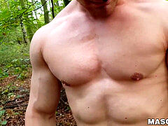 muscled stud milks his cock outdoors while wearing a mask