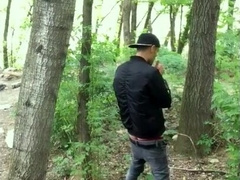 Bad guy strokes while smoking ciggy in a woods - nearly caught - so his scrotum linger utter