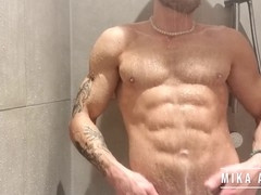 Hot tattooed guy Mika Ayden shows off his abs while dancing in the shower with his big soft cock
