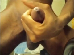 Black guy jacks off his big cock and cums hard