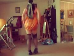 Energetic crossdresser dancing and swinging her pipe