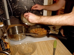 Beautiful cooking. Bare shirtlifter chef is cooking rice noodle with chicken and vegetables