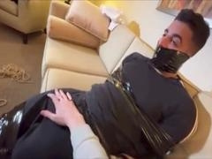 Bound guy wears Spidey costume tight