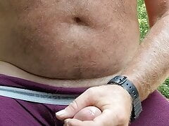 Jerking big dick in the bush