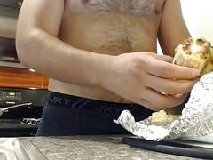 Chubby guy cooks naked in the kitchen