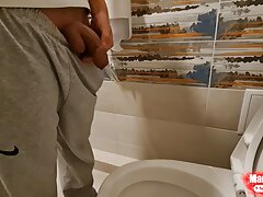 Young boy Mikel pissing at home