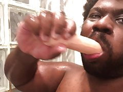 Sucking on a transgender cock sex toy in the shower