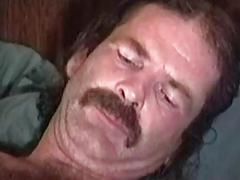 His body is covered in curly brown hair and his cock is uncut