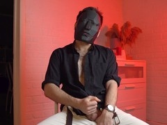 Masked hunk Noel Dero enjoys a solo session while watching raunchy scenes