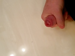 Uncut cock shooting a quick load on the table