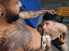 Tattooed Latino having fun with a submissive pale lad