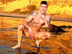 Solo dude with tattoos jerking his throbbing boner on the couch