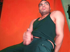 Enjoying a giant knob against a carrot-colored backdrop - GuitarJob's solo guitar jerk-off