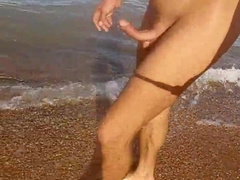 A mulatto ambles around the beach bare with an full salute