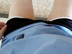 Korean boy undressing outdoors.