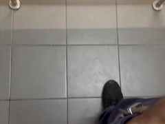 A muscled black security guard is having hump in a public rest room at the mall.