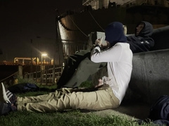 2 masculine folks, they don't know each other, urinating in a public place to greet each other.