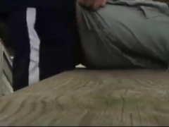 Fellow Nutting In Butt On A Bench