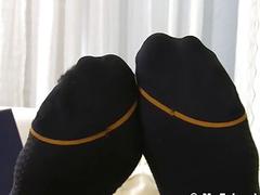 Tired businessman plays with his toes to relax