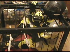 Caged bikerslave in full biker gear