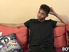 black youthfull guy gives an interview and stimulates himself