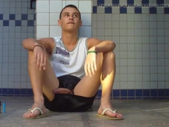 boy sitting in the douche flashes his huge knob