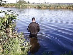 Wet worker swims fully clothed, wanking and cumshot on gear