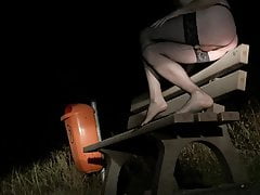 Crossdresser pissing on a bench in freezing cold