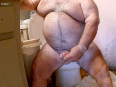 Hairy bear strokes off in the shower and his fur gets covered in cum
