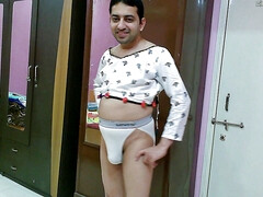 Hot crossdresser femboy Sweet Lollipop in a white crop top and thong.