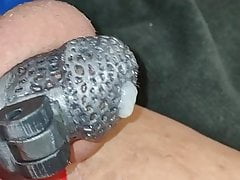 Cumming while caged with a fist dildo