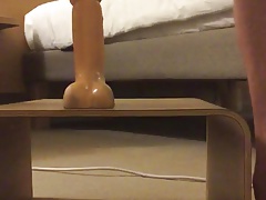 Young caged lad, riding a dildo