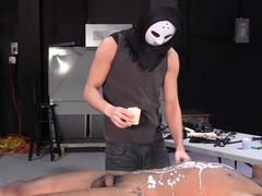BDSM top Damien Michael wears a mask while waxing Devon