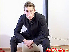 mind-blowing businessman showing off his ideal toes