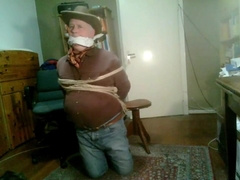 Cowboy In Dark Red Shirt Being Hold As Hostage