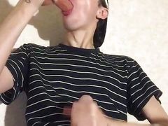 A young virgin sucks a dildo and jerks off his penis until he cums on his T-shirt