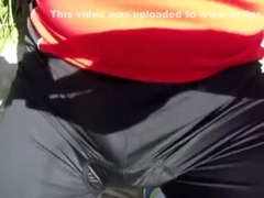 man pissing in public park