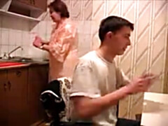 Son drills mother at the kitchen